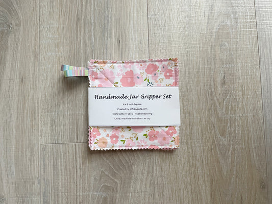 Pink floral handmade fabric jar gripper set of three with non-slip backing and ribbon loops for opening stubborn jar lids