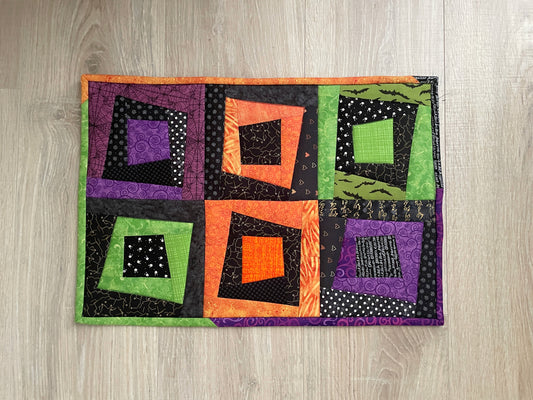 Extra‑large Halloween quilted hot pad with scrappy patchwork in fall colors