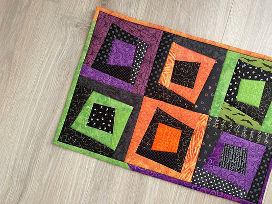 Extra‑large Halloween quilted hot pad with scrappy patchwork in fall colors