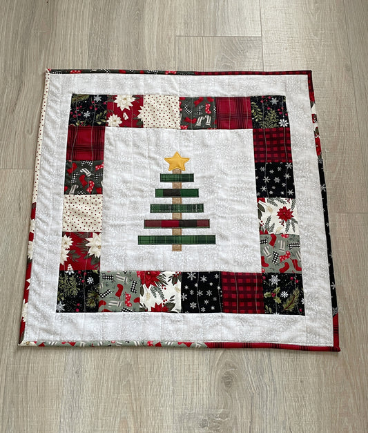 Christmas mini quilt or table topper featuring embroidered rustic tree in the center panel.