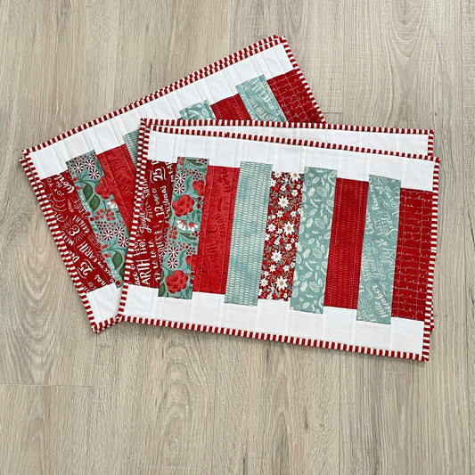 set of 4 handmade Christmas quilted placemats, modern patchwork in red, teal, and white.