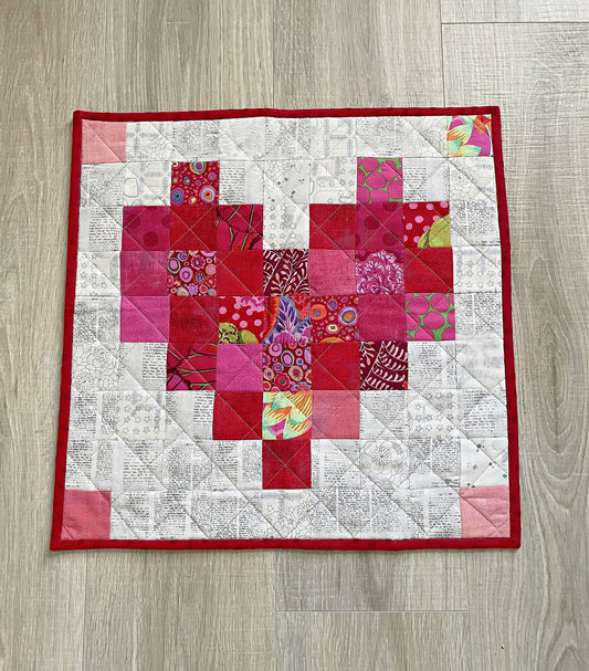 handmade pixelated heart mini quilt or table topper in reds and pink