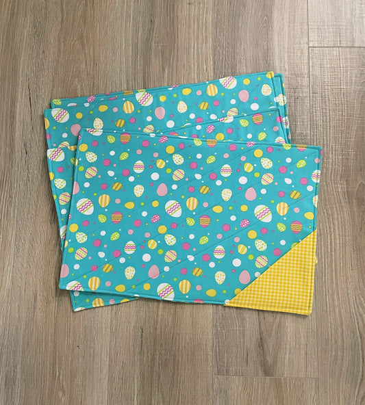 set of 4 Easter quilted placemats in yellow and blue, with a yellow gingham pocket on the front.