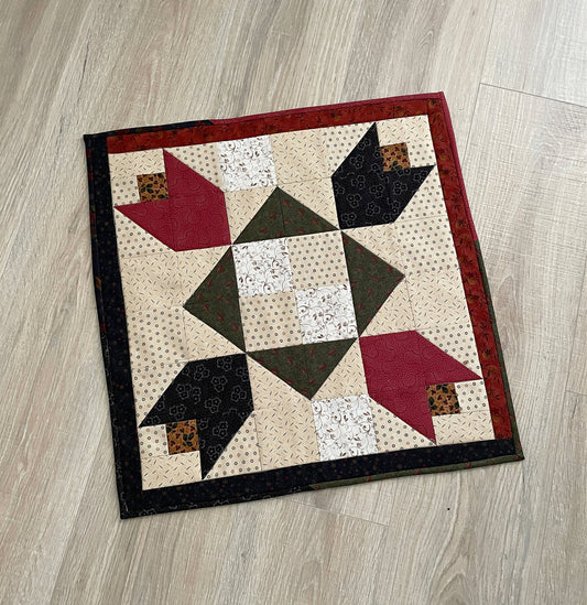 Scrappy table topper in country colors red, green, blue and tan. tulip patchwork