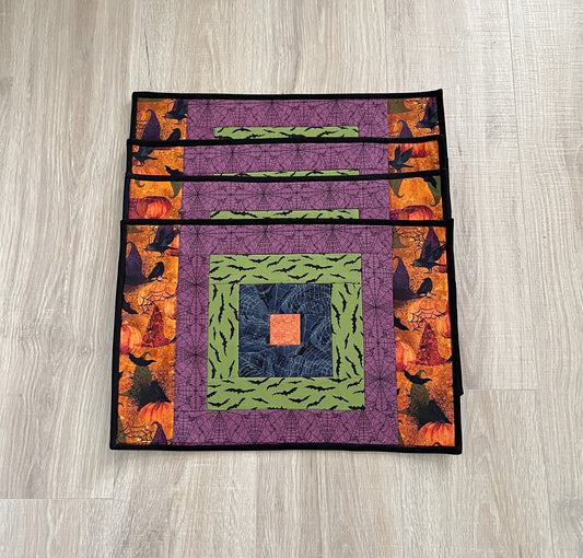 Set of four Halloween quilted placemats with courthouse‑steps quilt block design