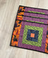 Set of four Halloween quilted placemats with courthouse‑steps quilt block design
