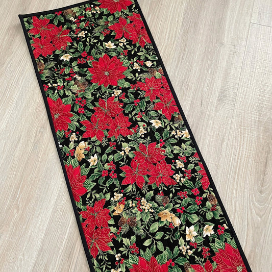 beautiful red and black Christmas table runner using a vibrant poinsettia fabric.