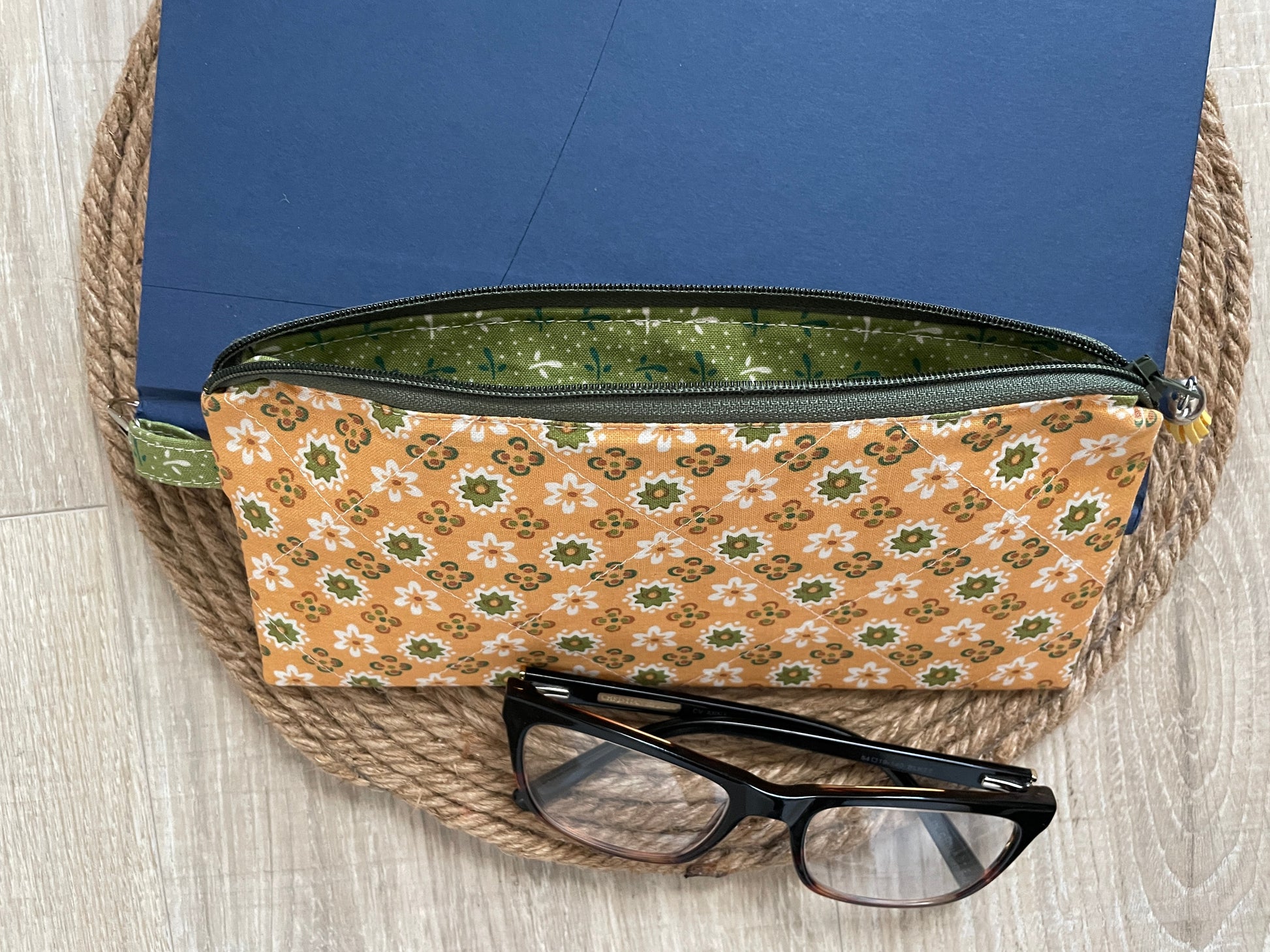 “Green and gold floral eyewear case made with vintage‑inspired Lori Holt Calico Days fabric, with zipper, tassel, and clip.”