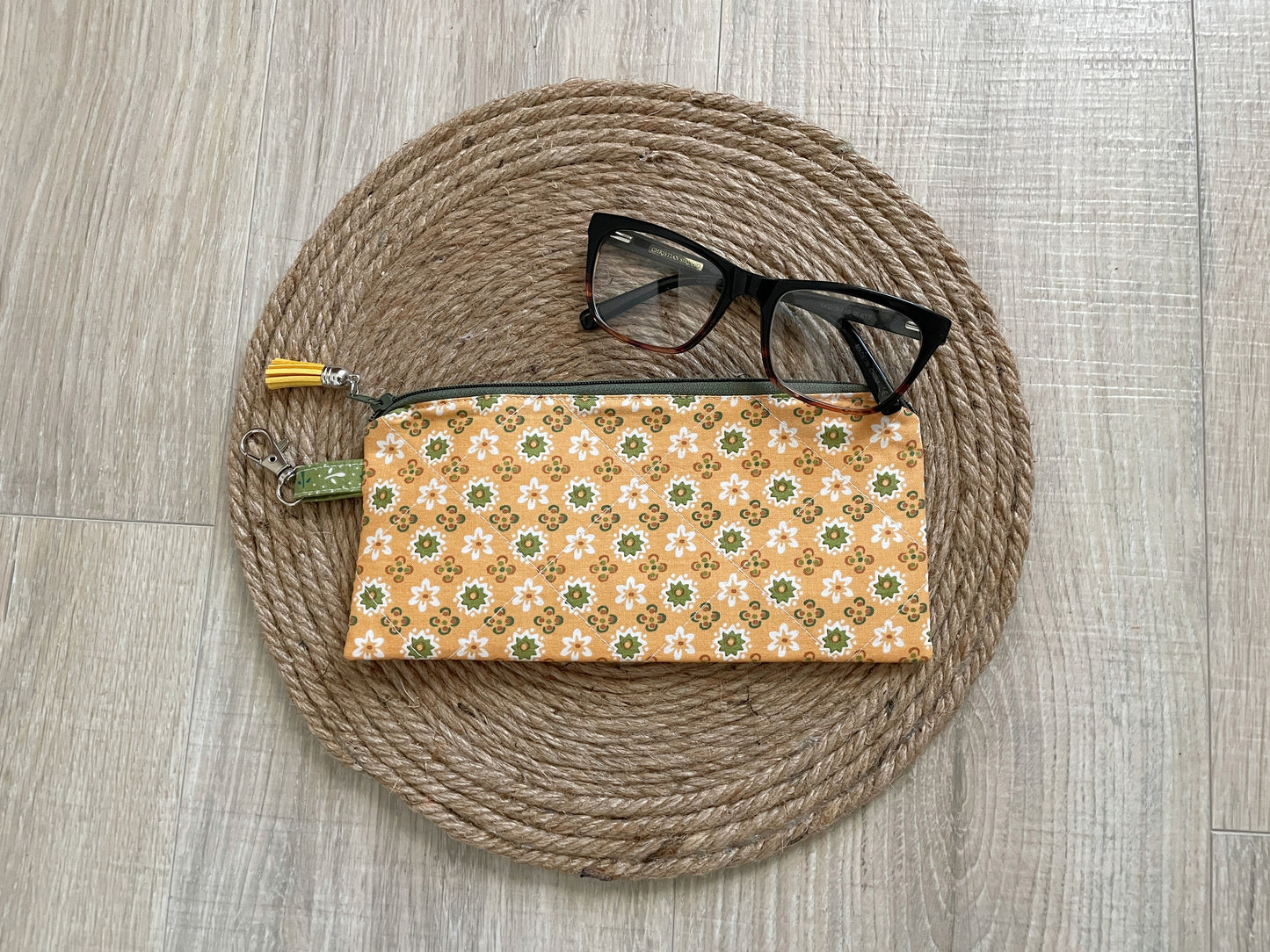 “Green and gold floral eyewear case made with vintage‑inspired Lori Holt Calico Days fabric, with zipper, tassel, and clip.”