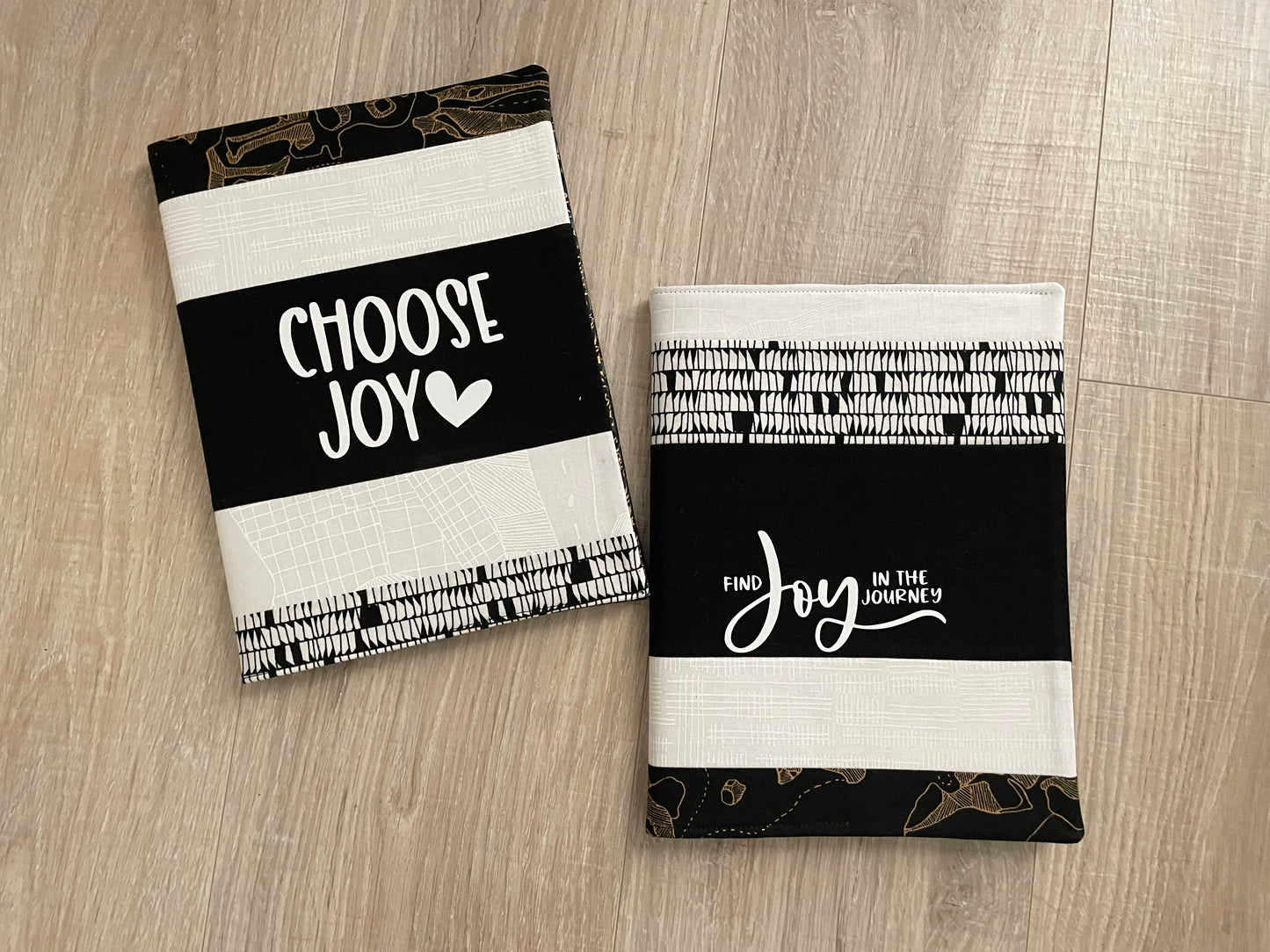 Handmade black and white quilted notebook covers featuring “Choose Joy” and “Find Joy in the Journey” designs