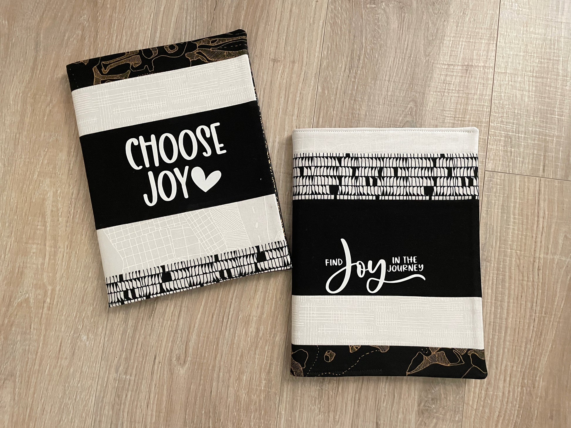 Handmade black and white quilted notebook covers featuring “Choose Joy” and “Find Joy in the Journey” designs