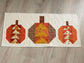 Autumn quilted table decor featuring flying geese pumpkin blocks