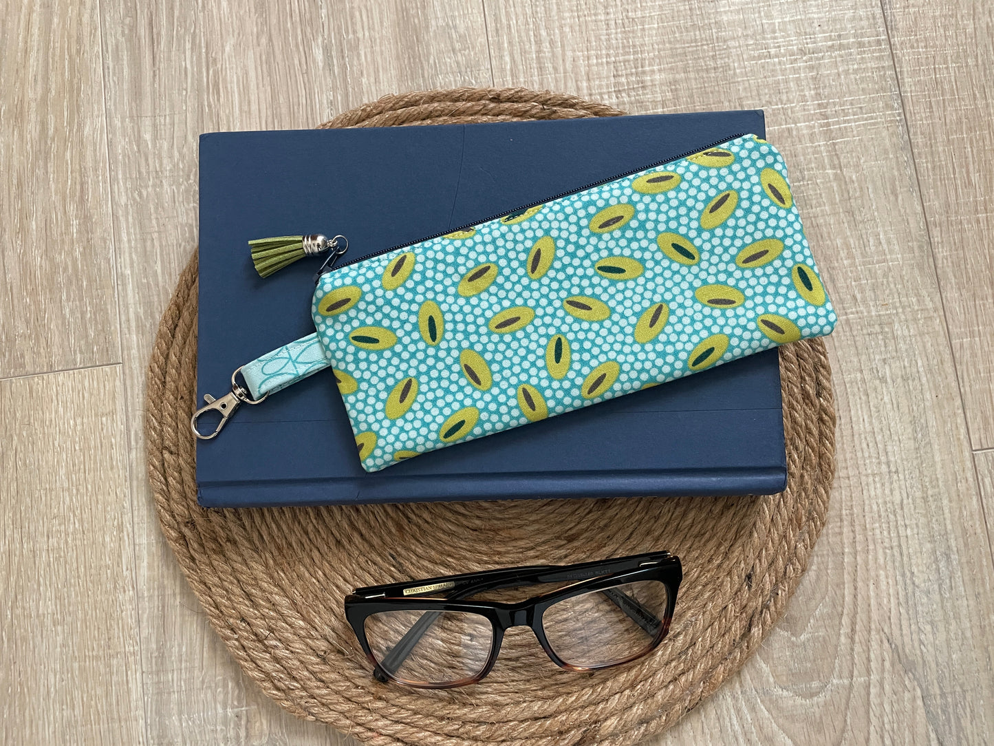 Blue and green retro oval print quilted eyewear case with zipper, leather tassel, and swivel hook