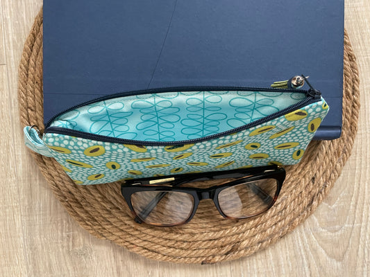 Blue and green retro oval print quilted eyewear case with zipper, leather tassel, and swivel hook