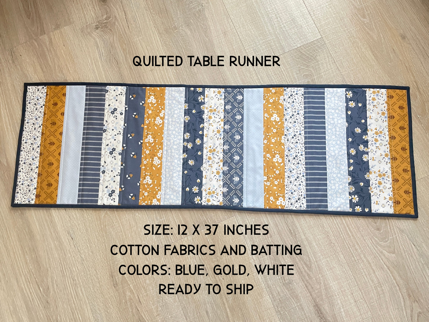 Quilted table runner with floral and bee prints in blues and golds