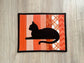 Quilted orange mug rug with black cat appliqué, handmade 8x10 snack mat.