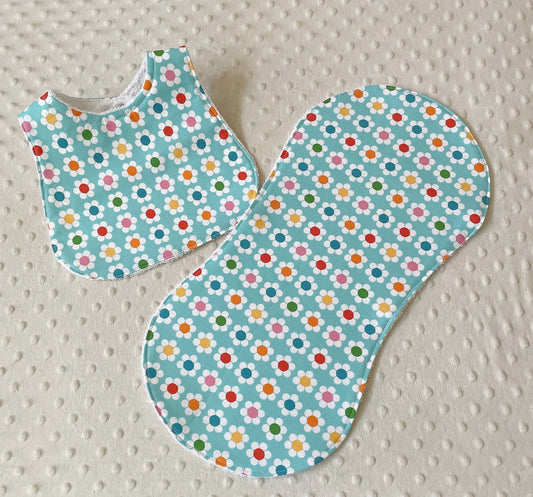 baby girl bib and burp cloth gift set using retro daisy flowers on an aqua background