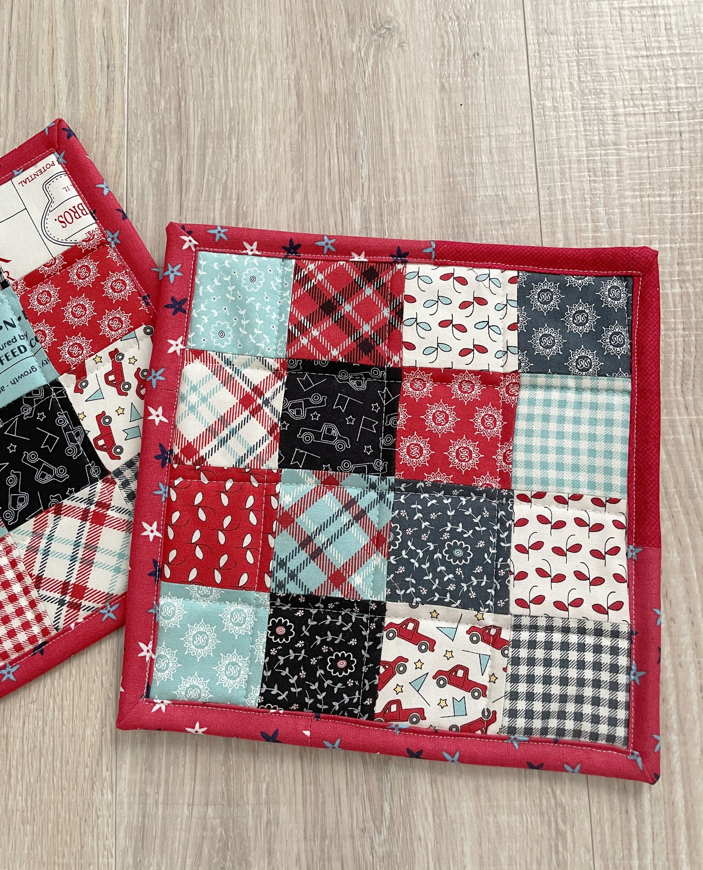 This set of 2 red, white, and blue patchwork potholders / hot pads will be a great addition to your country farmhouse kitchen décor.  Each finished hot pad/potholder is generously sized at 8.5 x 8.5 inches. 