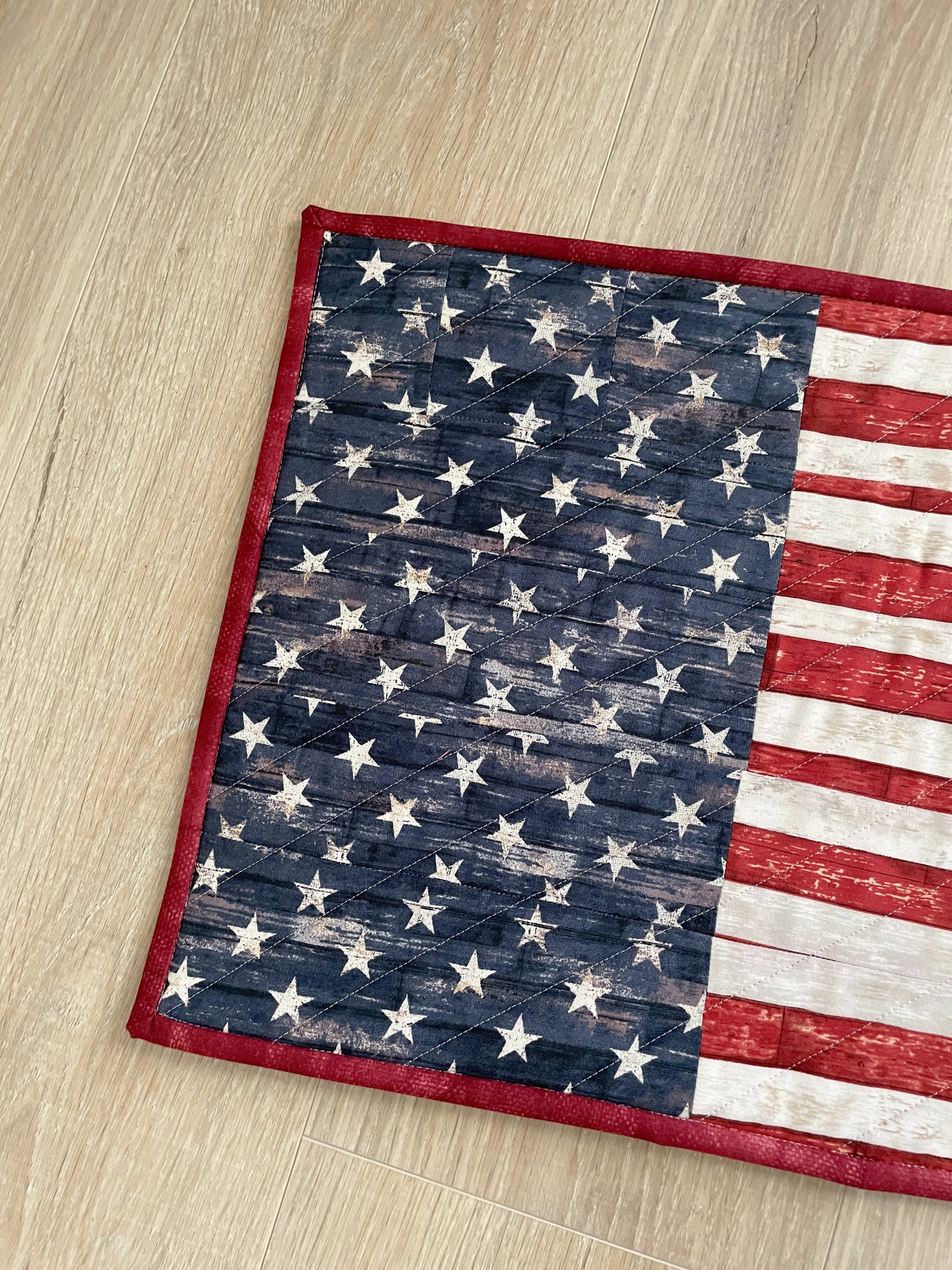 This lovely red, white, and blue quilted casserole hot pad makes your table beautiful! Measuring 13 x 16 inches, this handmade kitchen trivet features a scrappy improv patchwork resembling the American Flag, making it perfect for a 9 x 13 casserole dish or 2 smaller baking dishes.