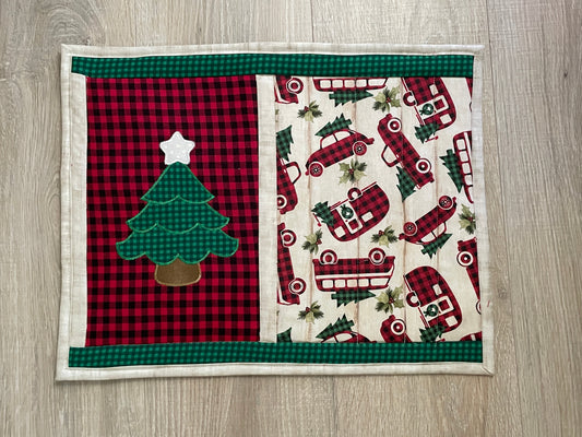 Handmade quilted Hot pad measuring 13 x 17 inches. Center features machine embroidered Christmas tree and vintage style autos in red/black buffalo plaid focal fabric. Backed in red and black gingham print. 2 layers of cotton batting and on layer of insulated batting.