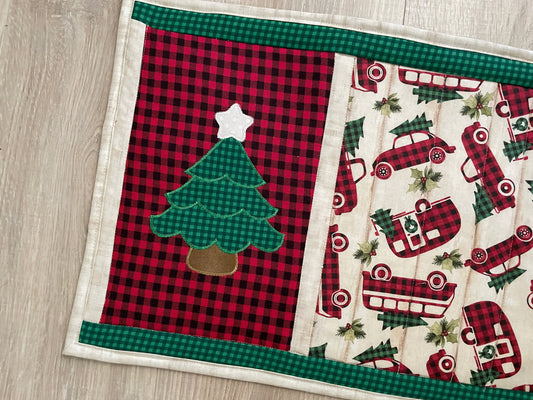 Handmade quilted Hot pad measuring 13 x 17 inches. Center features machine embroidered Christmas tree and vintage style autos in red/black buffalo plaid focal fabric. Backed in red and black gingham print. 2 layers of cotton batting and on layer of insulated batting.
