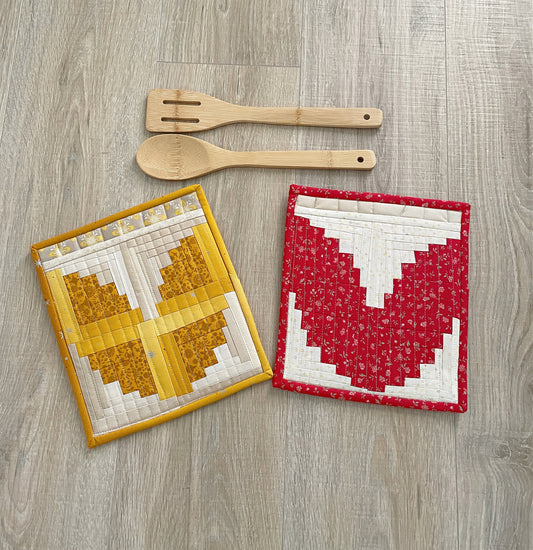 set of two handmade quilted pocket potholders using the log cabin quilt block to form the shape of a tulip.
