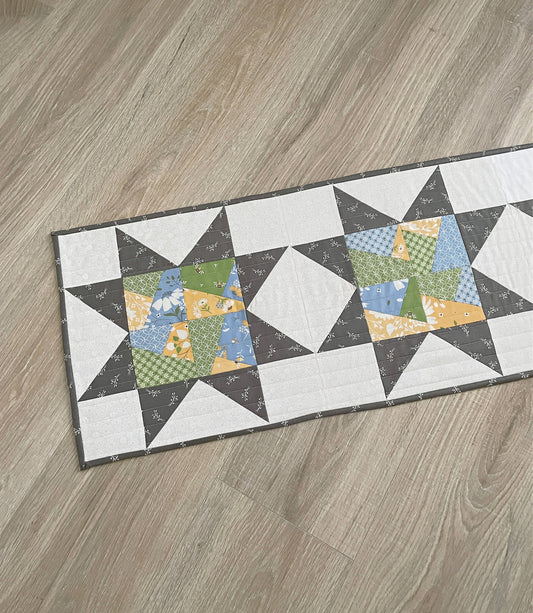quilted table runner with crazy patch stars in green, yellow and blue. Perfect for spring.