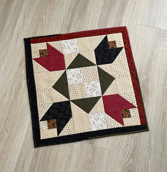 Scrappy table topper in country colors red, green, blue and tan. tulip patchwork